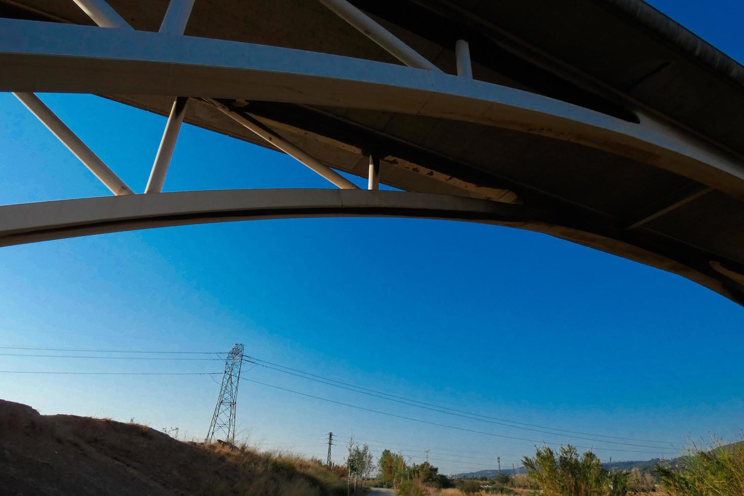 Arch of a modern bridge crossing a river photo