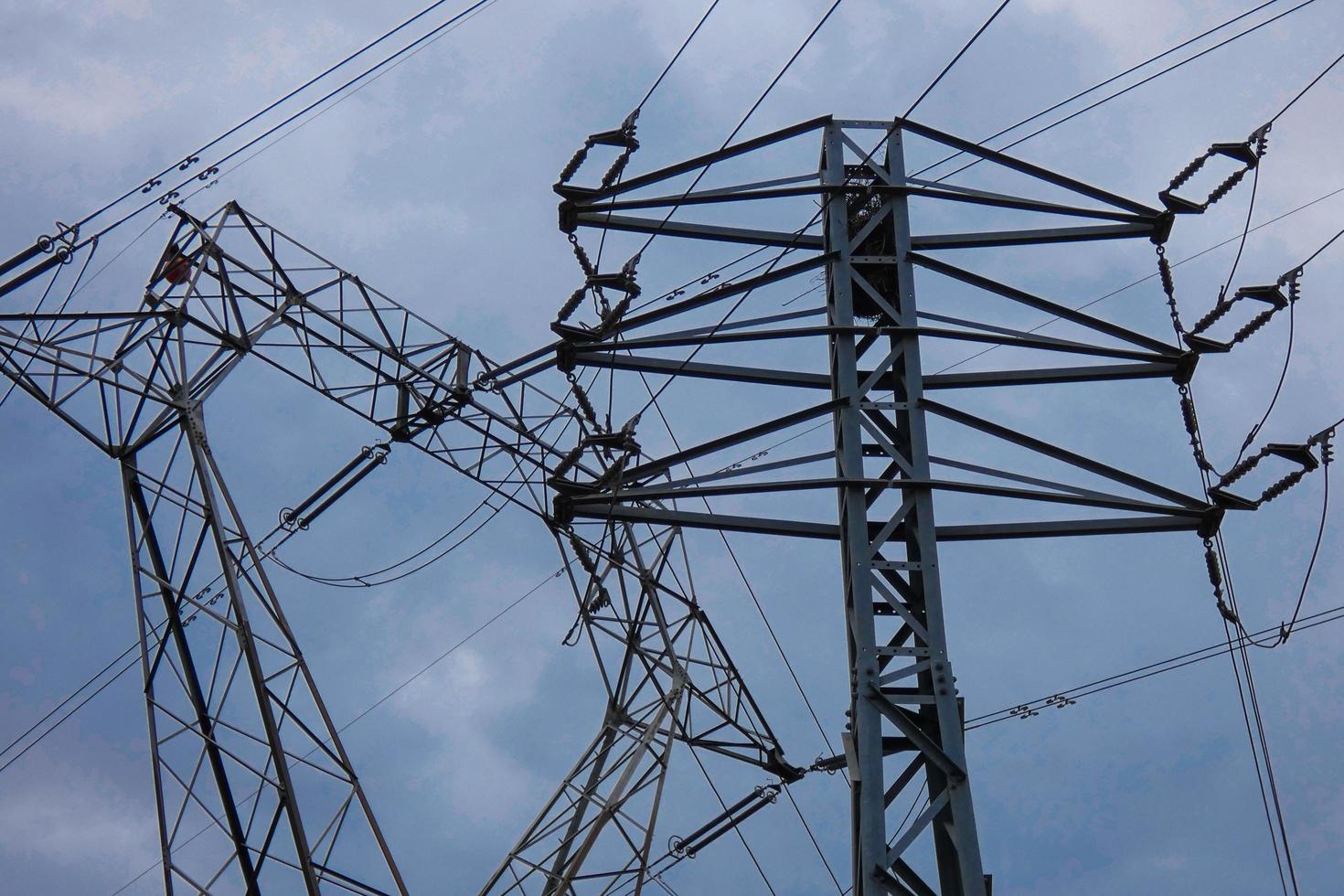 Electric towers supporting the copper cables that transmit and transport electricity photo