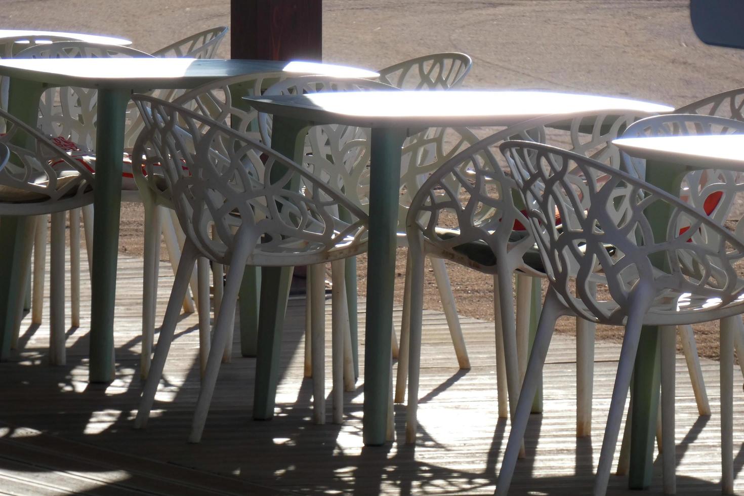 White metal tables and chairs for outdoor and garden use photo