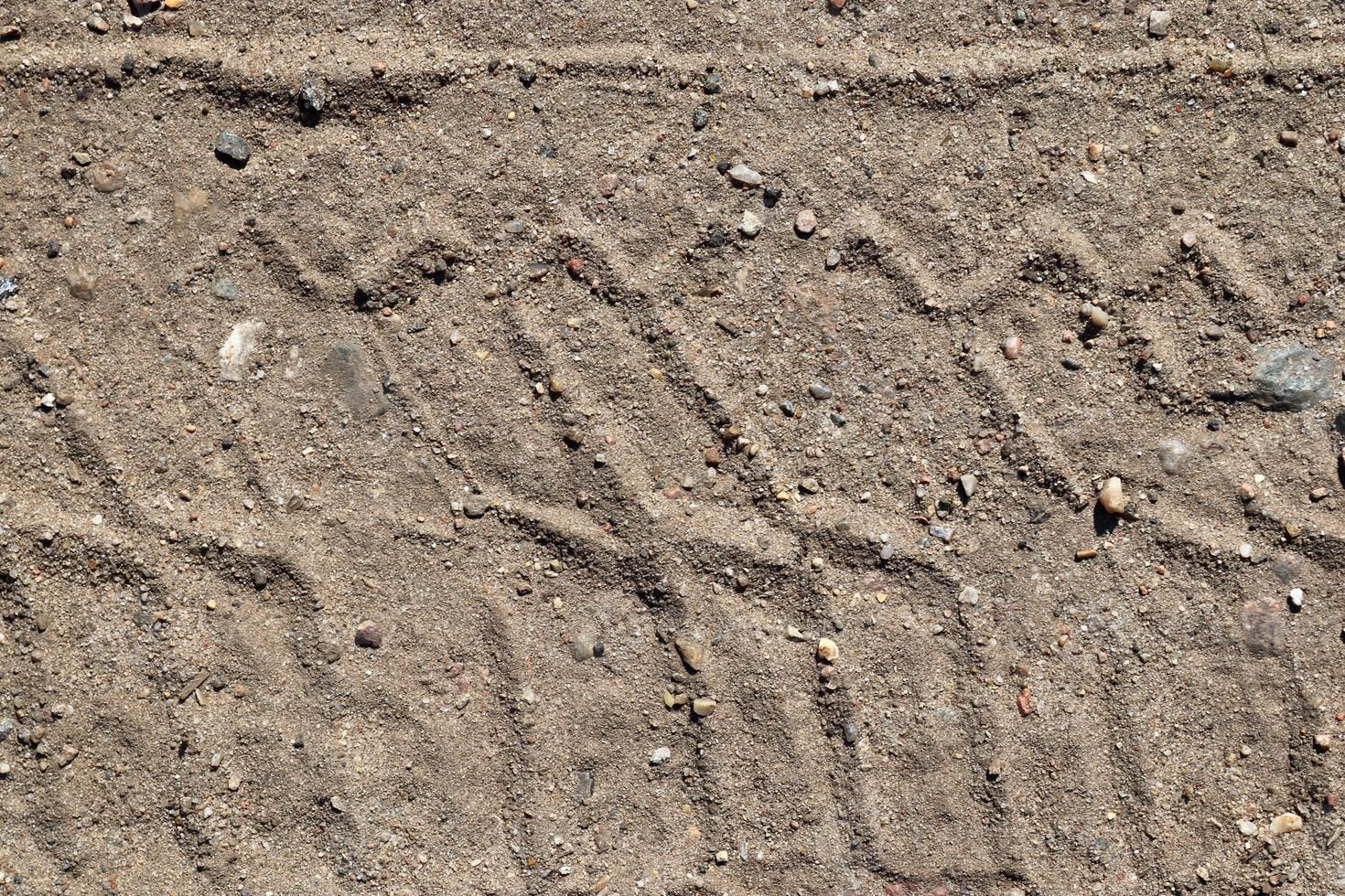 Detailed close up view on a brown sand ground texture photo