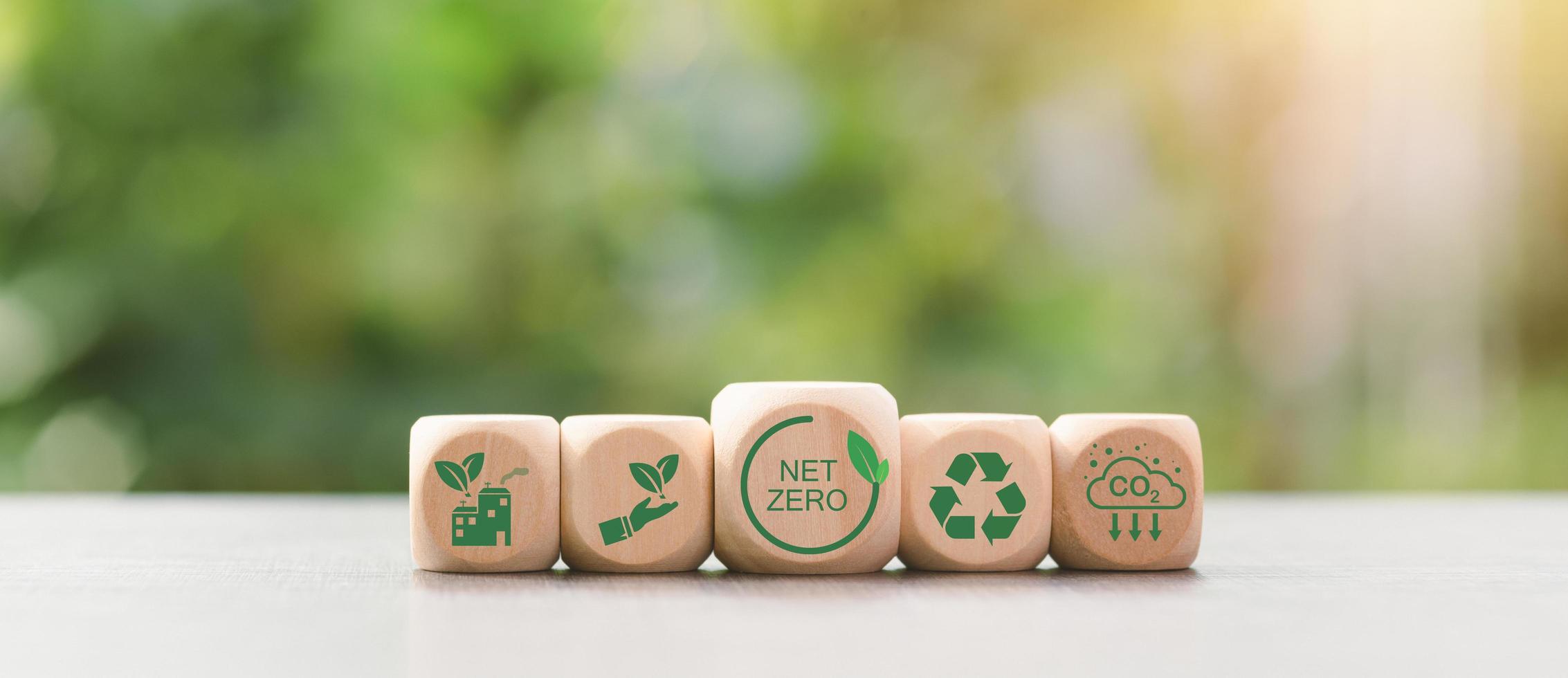 Wooden blocks and icons representing the concept of caring for nature together,Net Zero,Carbon Neutral Concepts ,Greenhouse Gas Reduction Policy,Carbon Neutral,Environmental Mind,Green Industry. photo