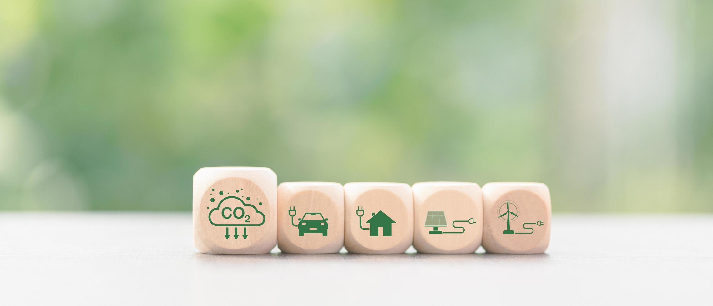 Industrial emissions pollute the environment and ecosystems. including climate change Carbon Renewable Energy Agreement reduce greenhouse gas emissions ,icon and wooden blocks on table photo