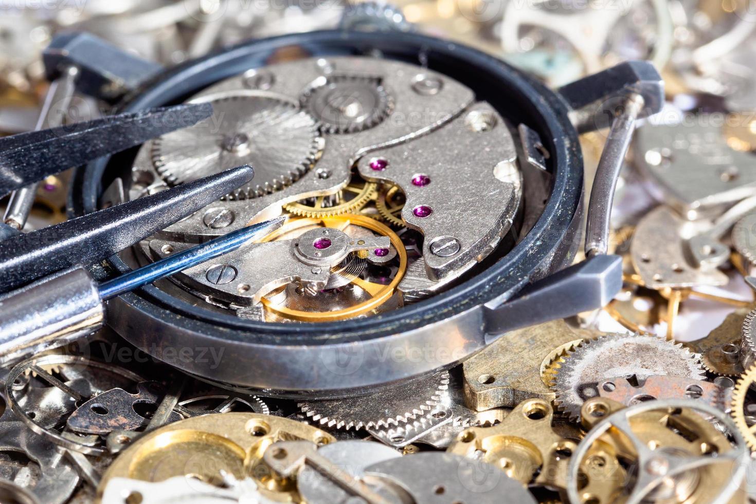 tools on open watch on clock spare parts photo