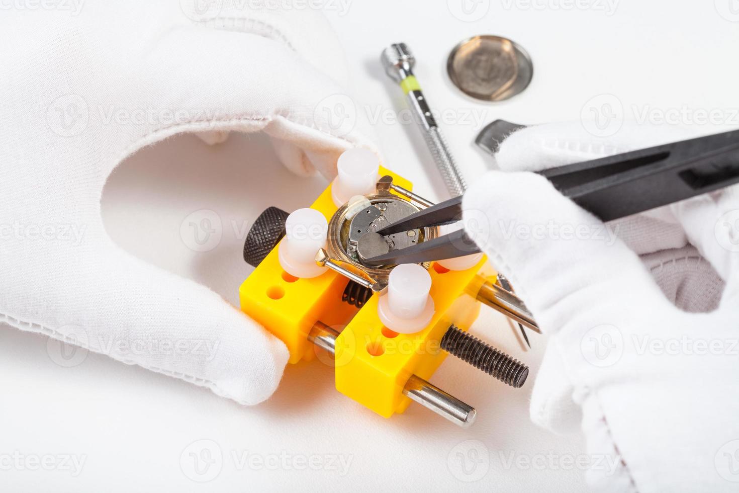 replacing a battery in quartz watch by tweezers photo