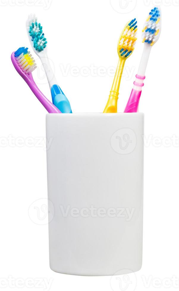 four tooth brushes in ceramic glass photo