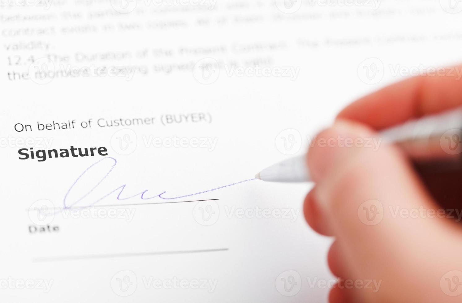 customer signing sales contract by silver pen photo