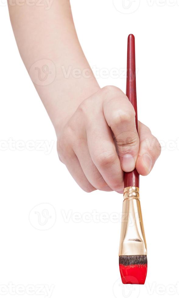 direct view of hand with red art flat paintbrush photo