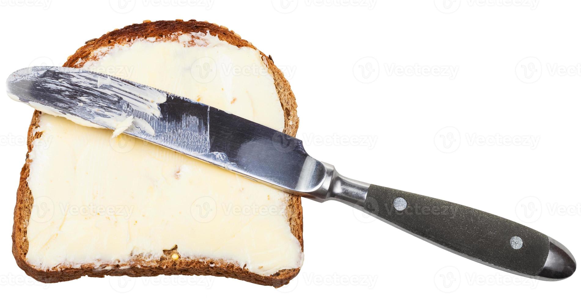 grain bread and butter sandwich with table knife photo