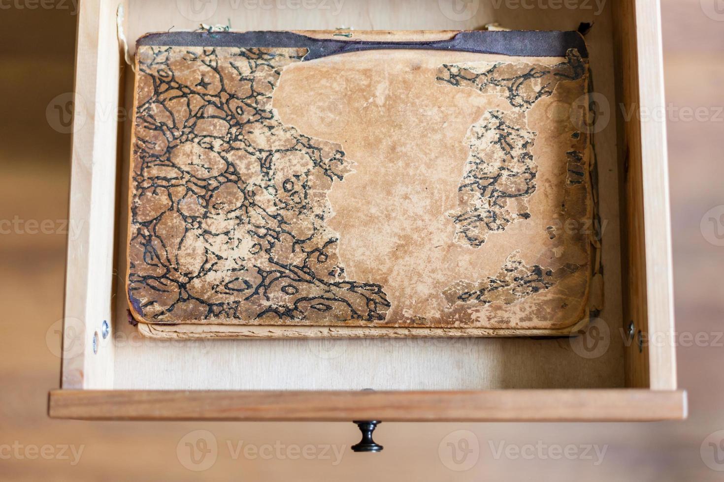 shabby book in open drawer photo