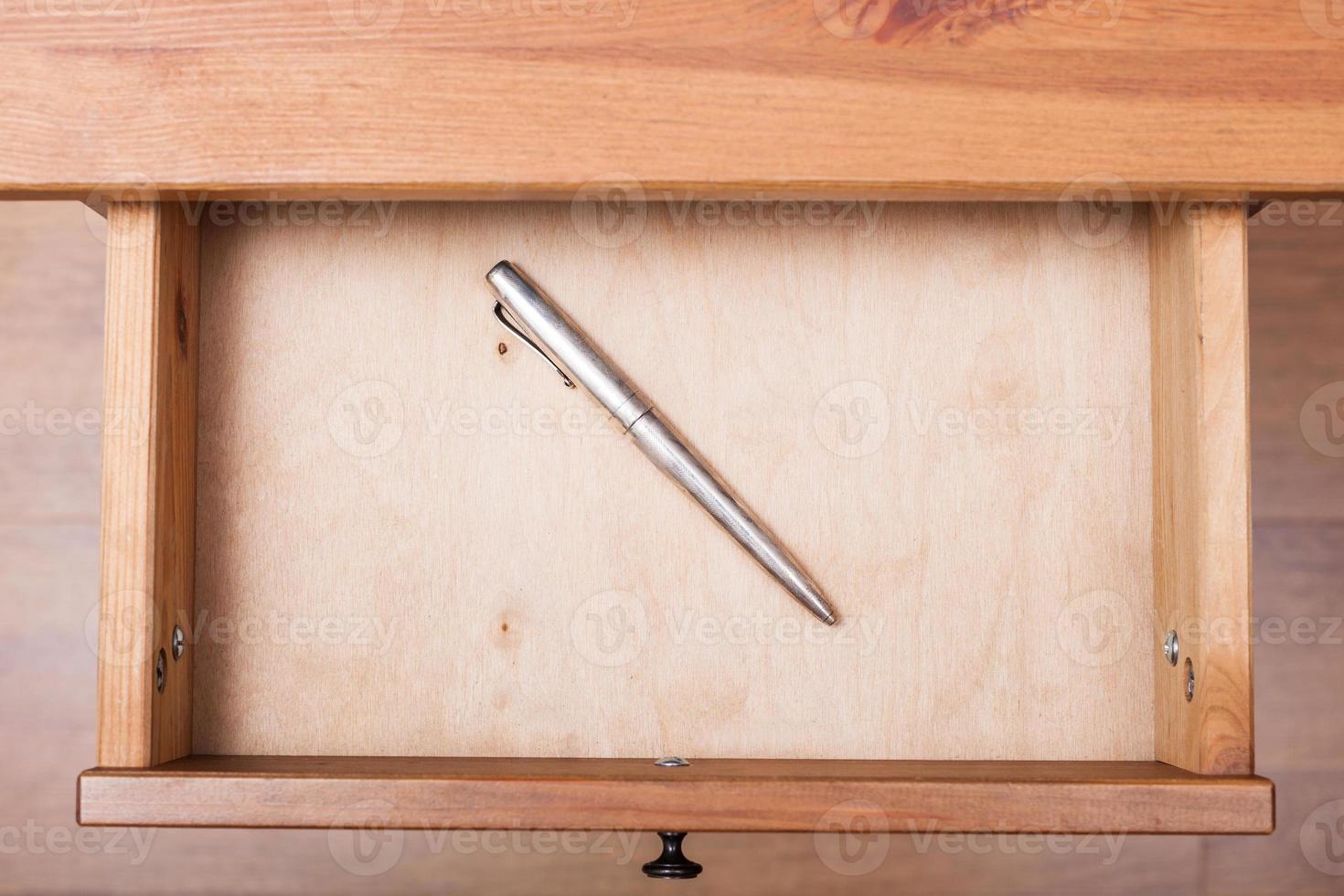 old silver pen in open drawer photo