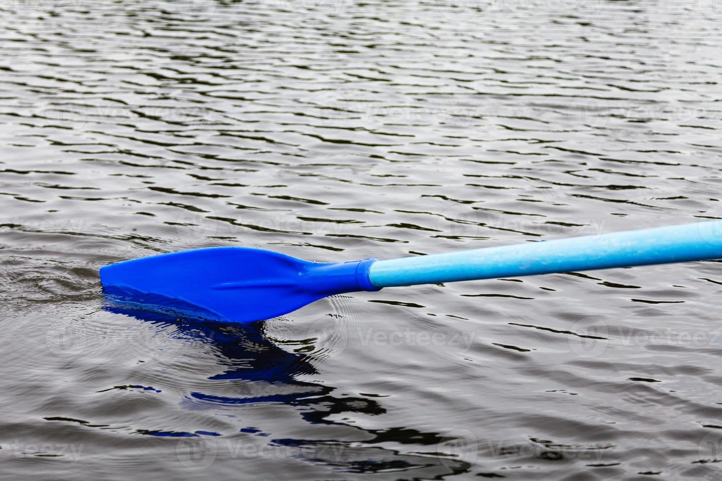 oar blade in water during boating photo