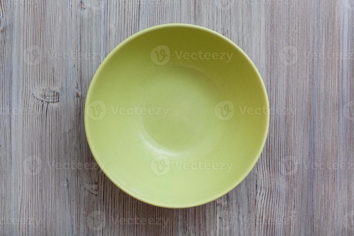 above view of green bowl on gray brown table photo