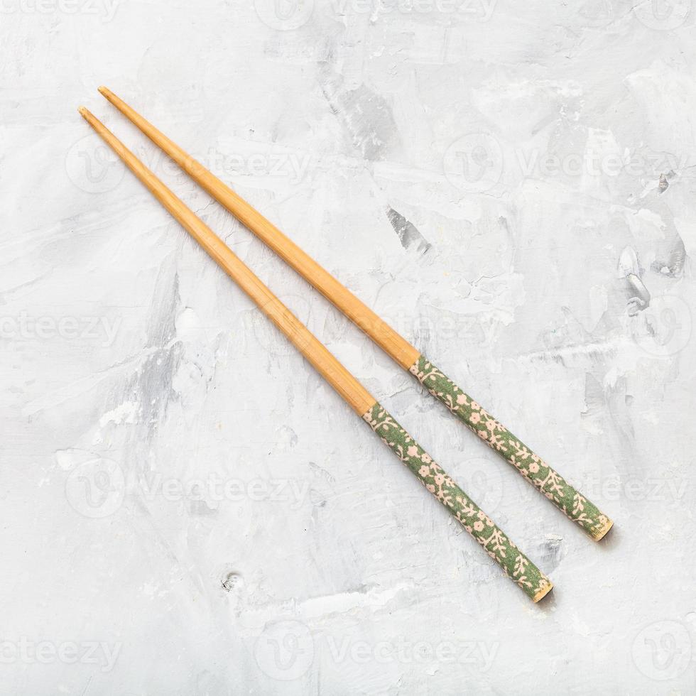 wooden chopsticks on concrete board photo