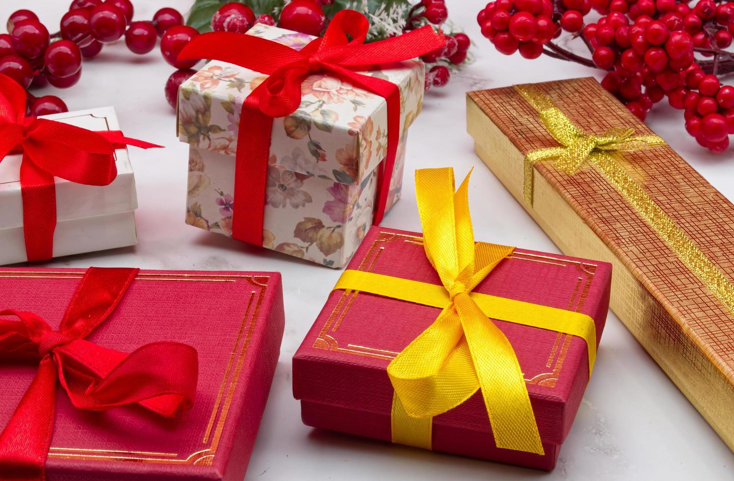 Christmas gift boxes on marble table. Christmas ornaments. photo