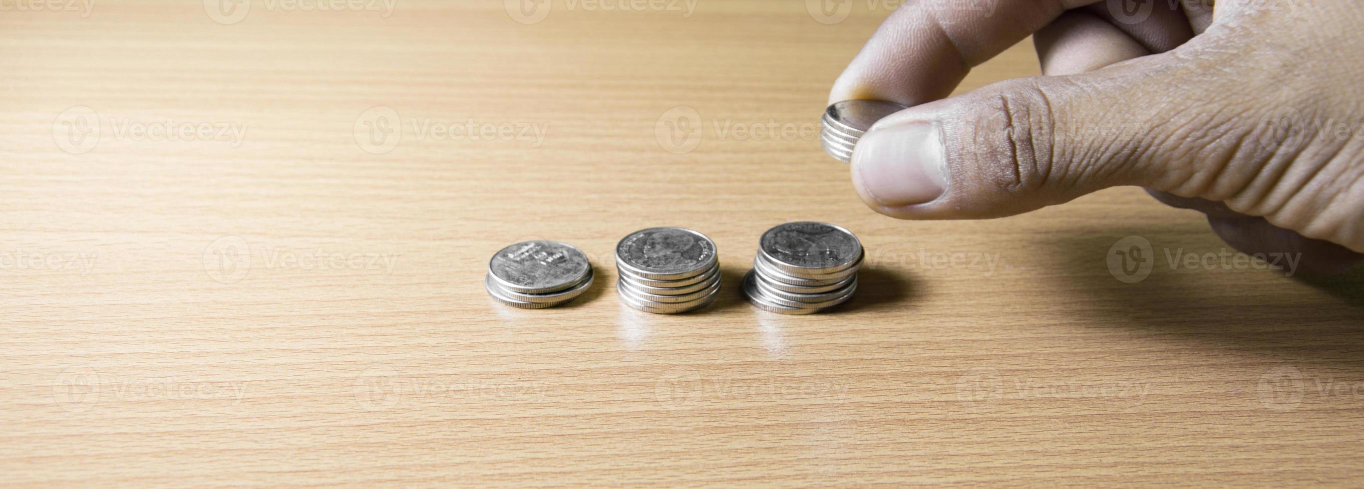 Silver coins stacked in a ladder on a wooden floor, concept, savings, finance, bank, profit photo