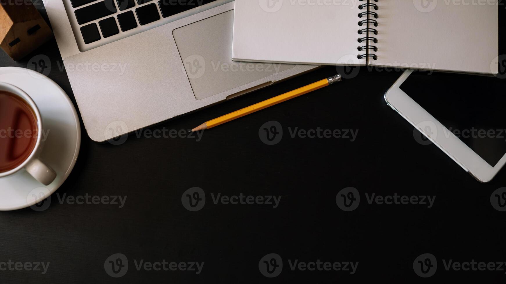office stuff with tablet, laptop ,smartphone and coffee cup notepad and documents photo