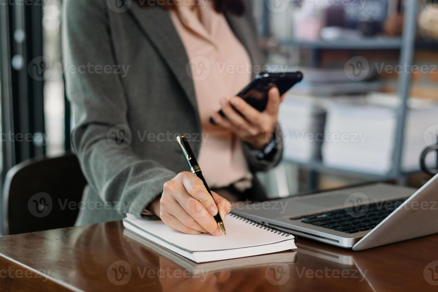 businesswoman hand working with new modern computer and writing on the notepad strategy diagram photo