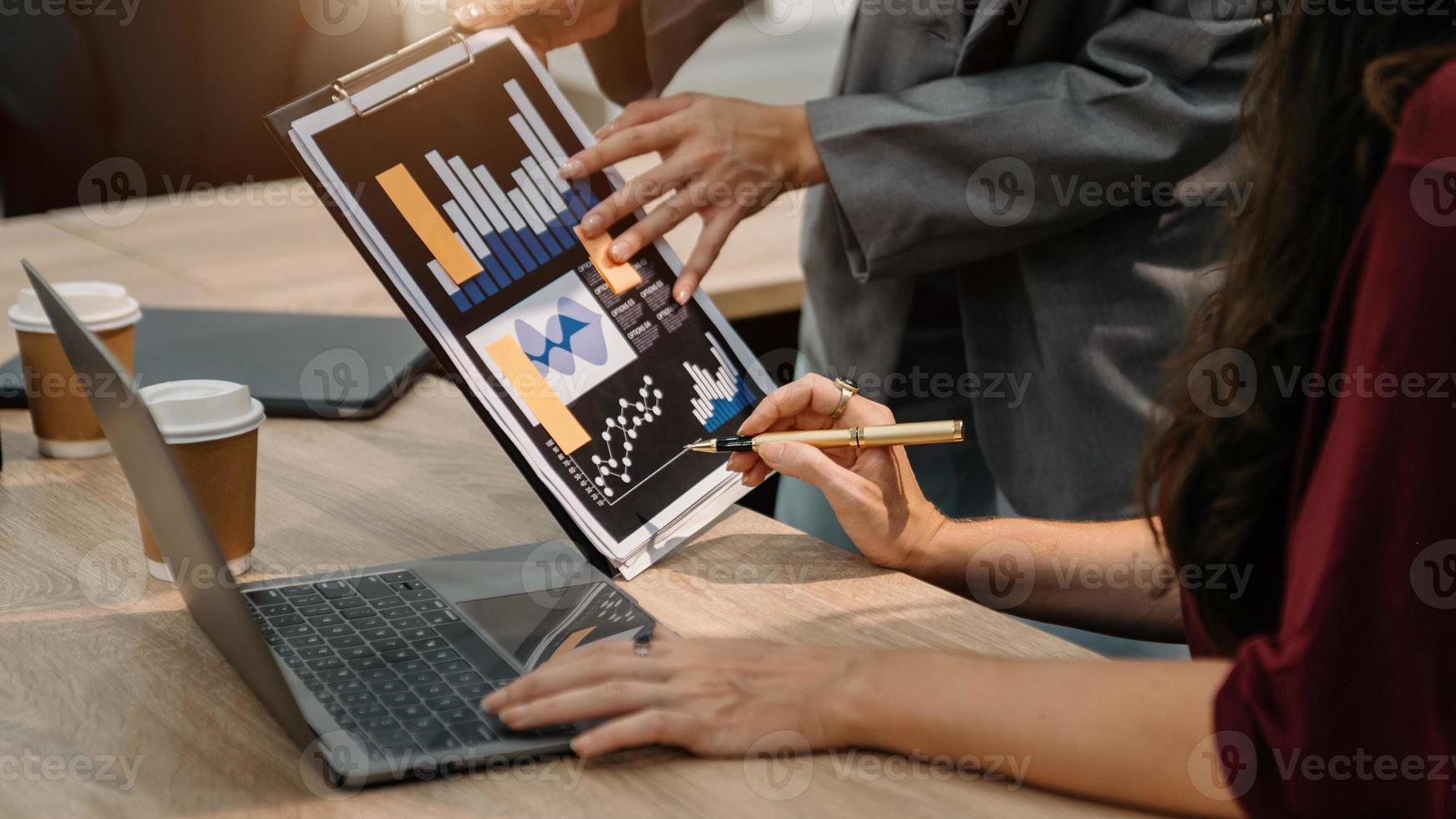Bussinessman analyzing sales data and economic growth and pointing at business report document with graph chart financial chart marketing, banking and payments at office photo