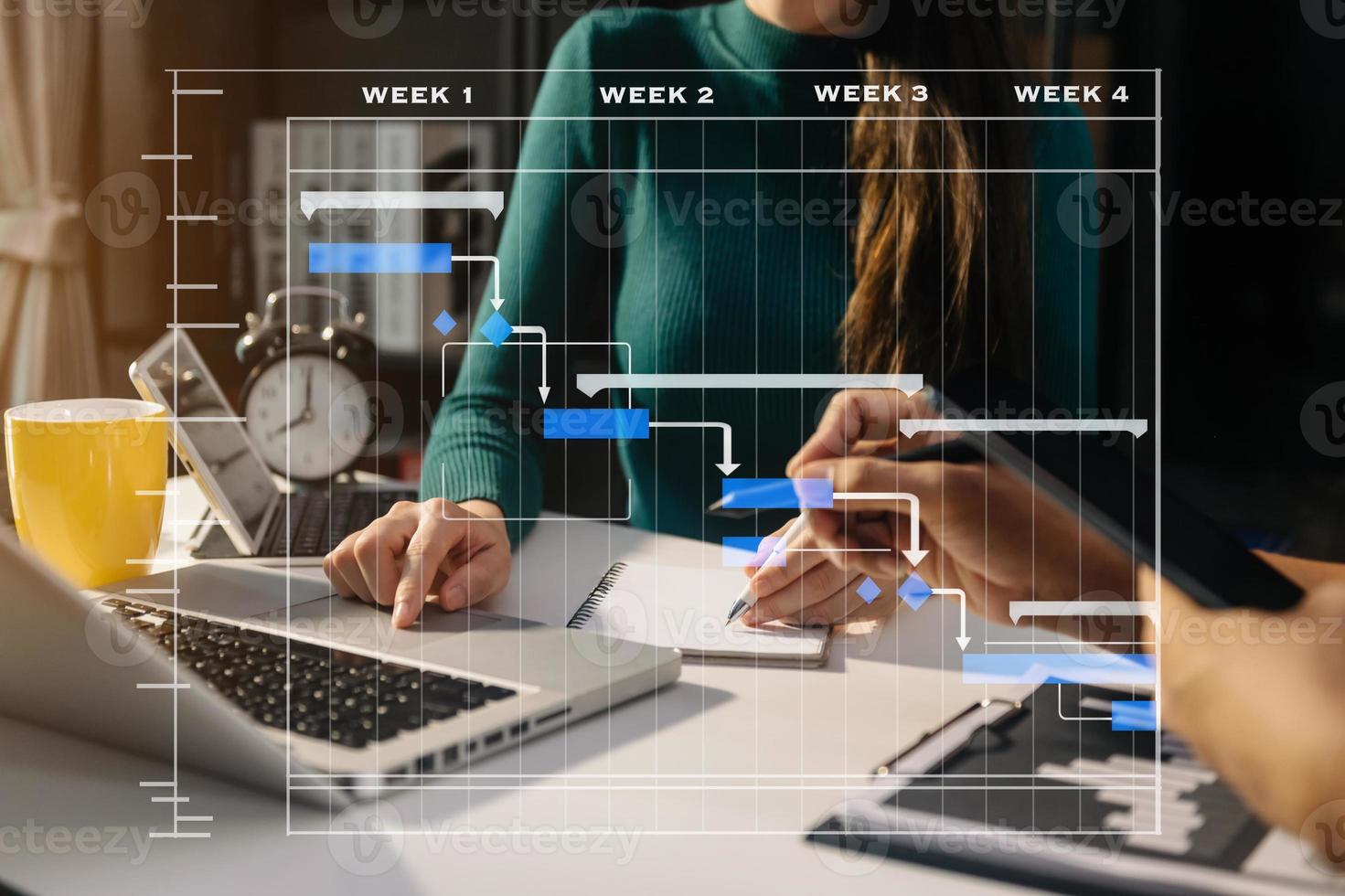 Project manager working and update tasks with milestones progress planning and Gantt chart scheduling diagram. business working with smart phone, tablet and laptop in office. photo