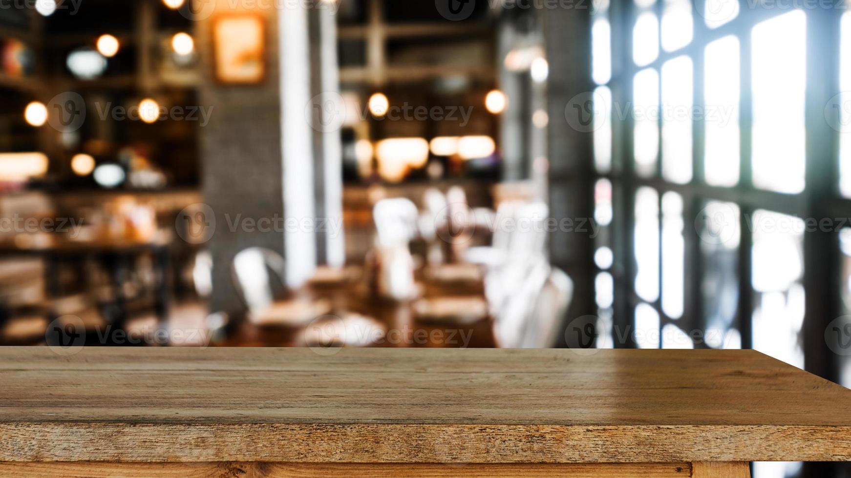 Empty dark wooden table in front of abstract blurred bokeh background of restaurant . can be used for display or montage your products. photo