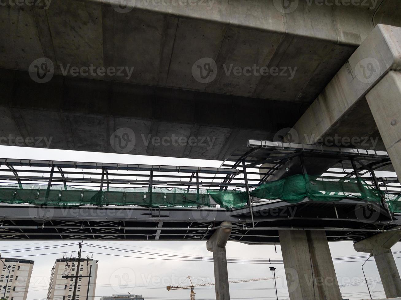 The construction site of the pedestrian overpass along the concrete pillar. photo