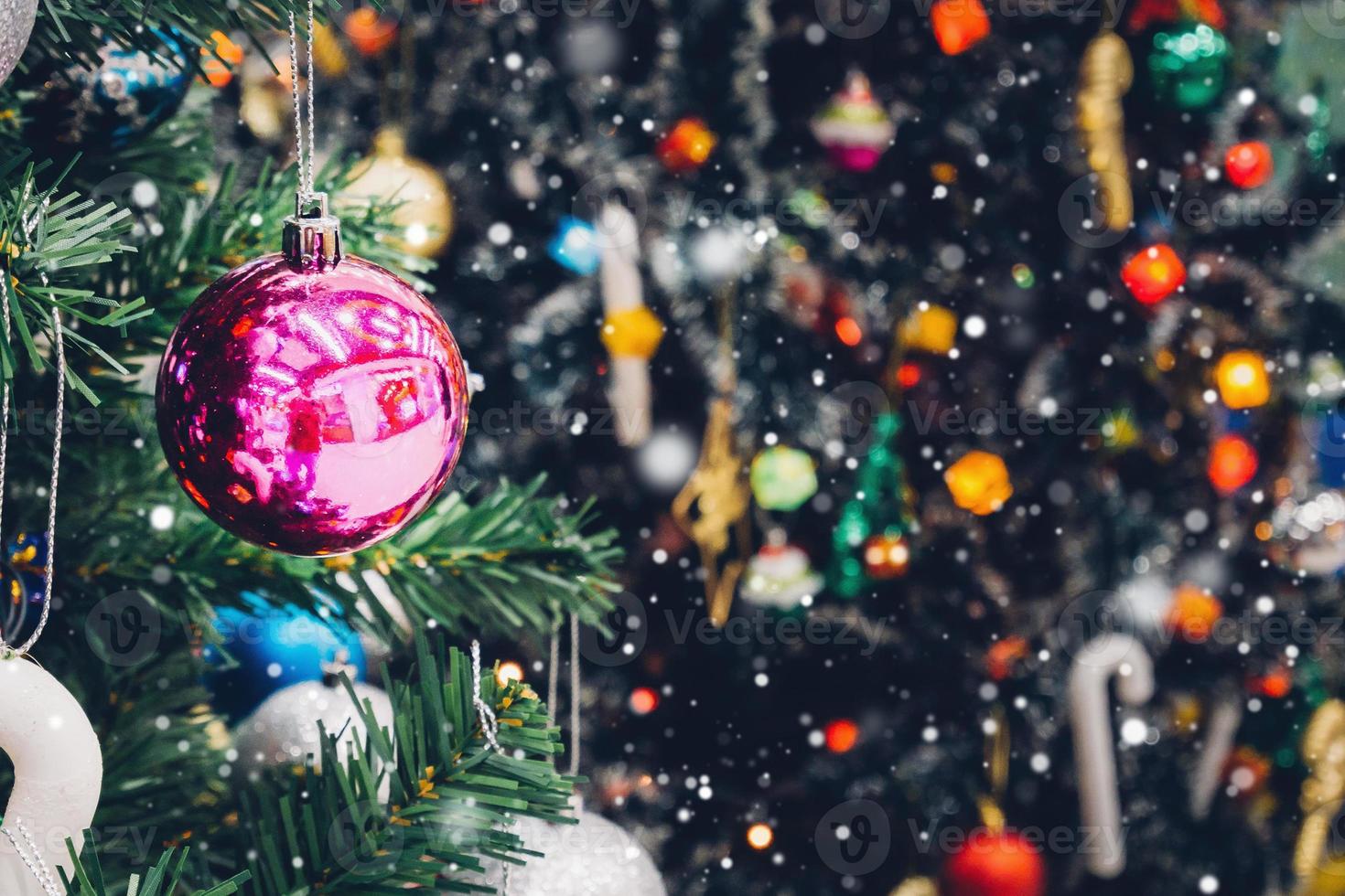 Decorated Christmas tree with colorful bauble on sparkling bokeh light blurred background photo