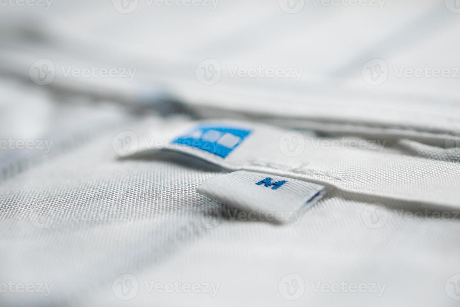 White clothes label close up on new shirt photo