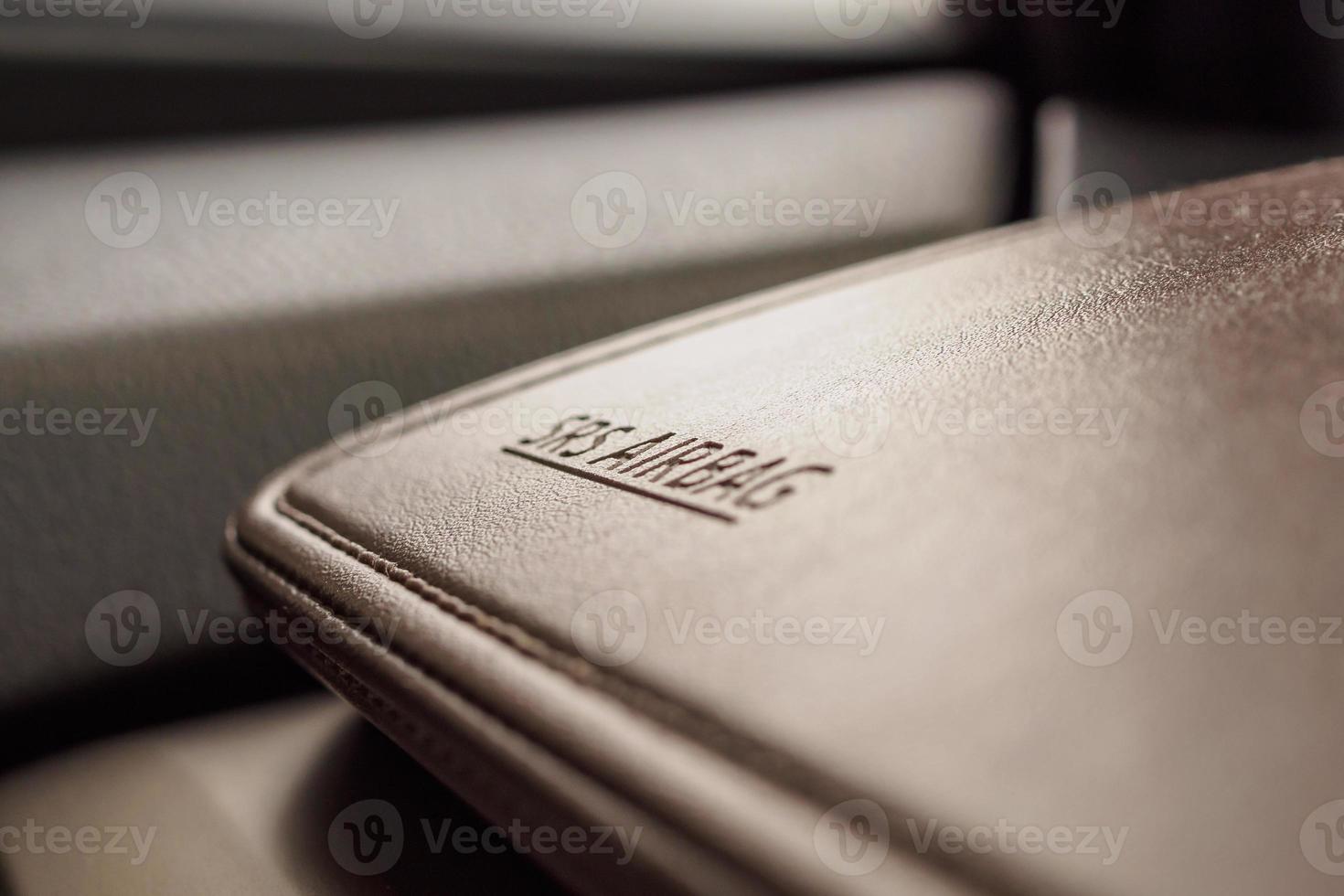 airbag safety sign on brown leather texture in modern car photo