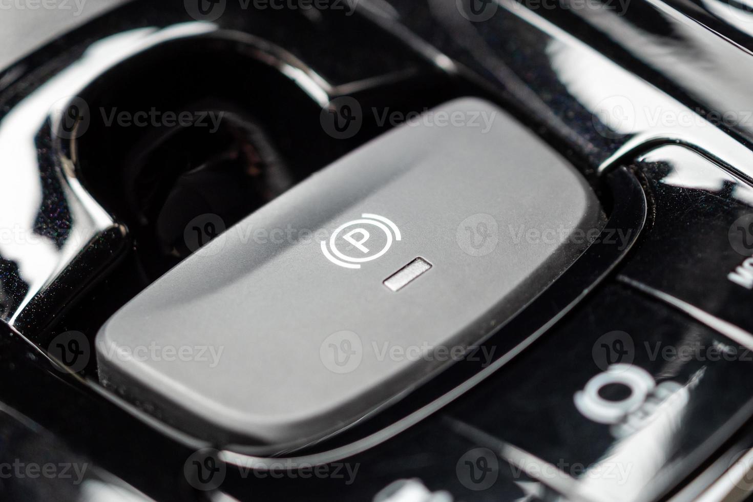 electronic handbrake button in luxury modern car photo