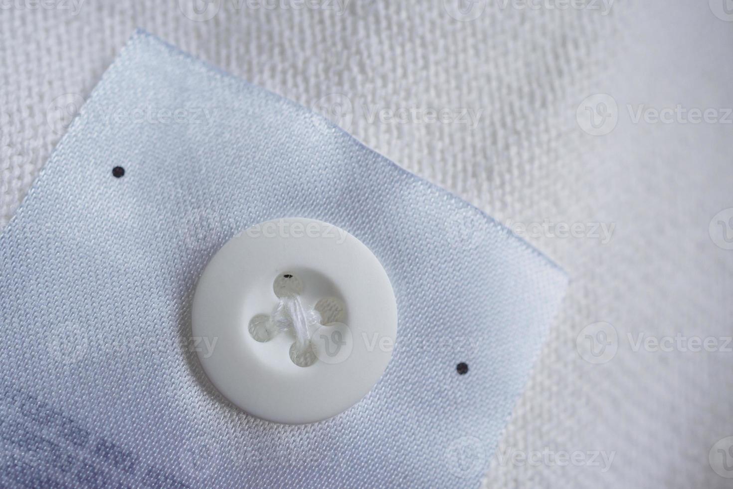 laundry care clothing label with button on cotton shirt photo