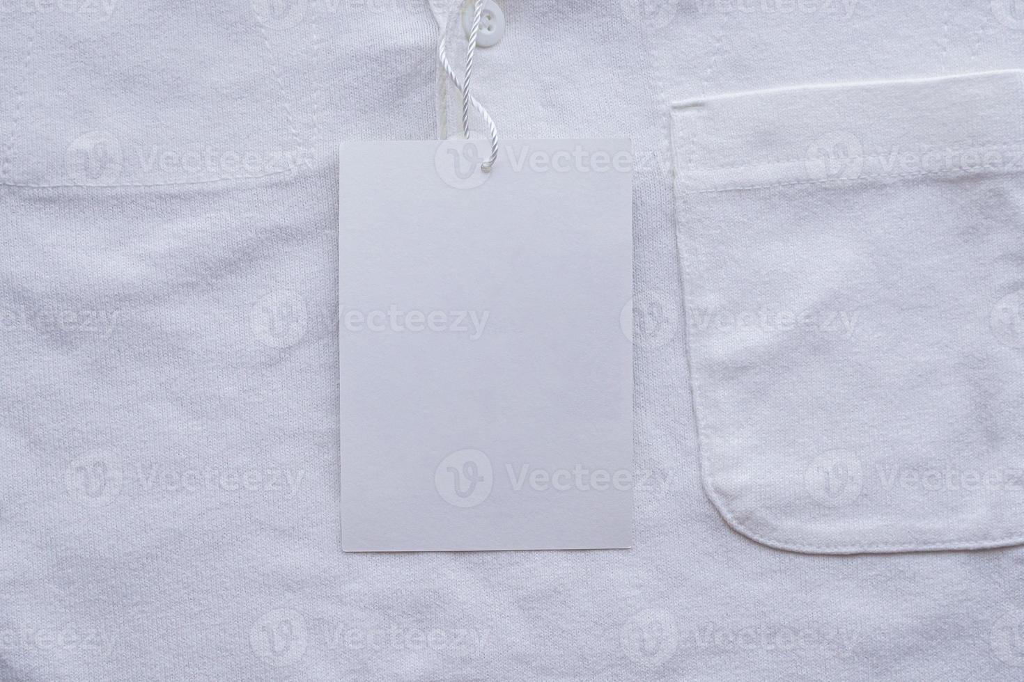 Blank white clothes tag label on new shirt photo