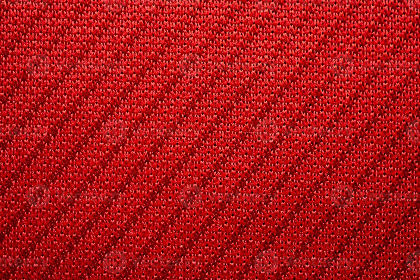 Red sports clothing fabric football jersey texture close up photo
