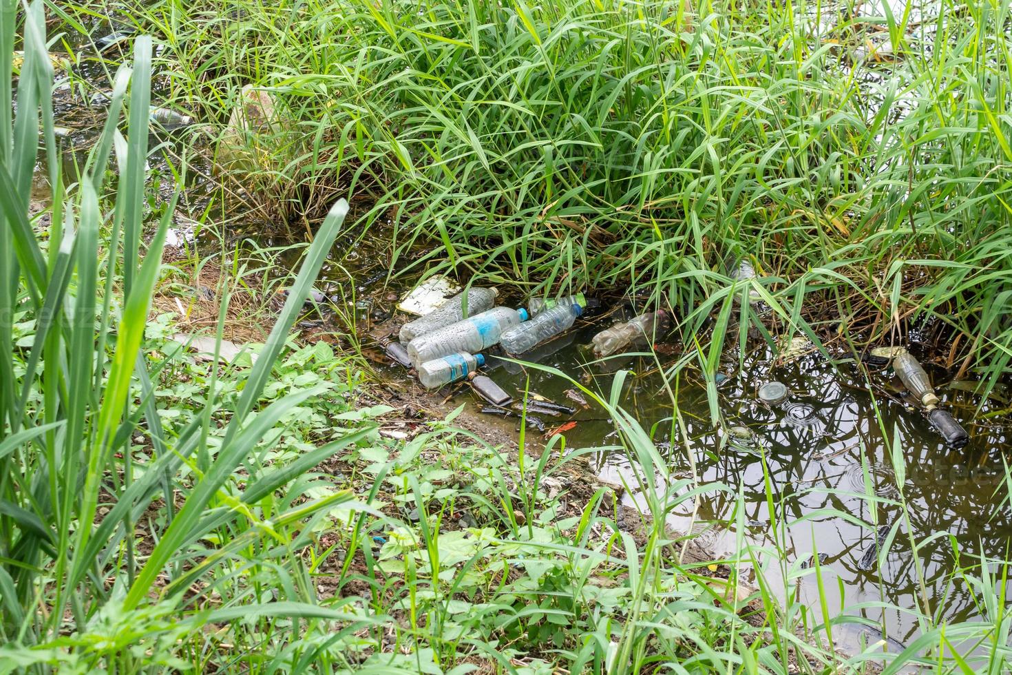 Plastic pollution in water pond environment photo