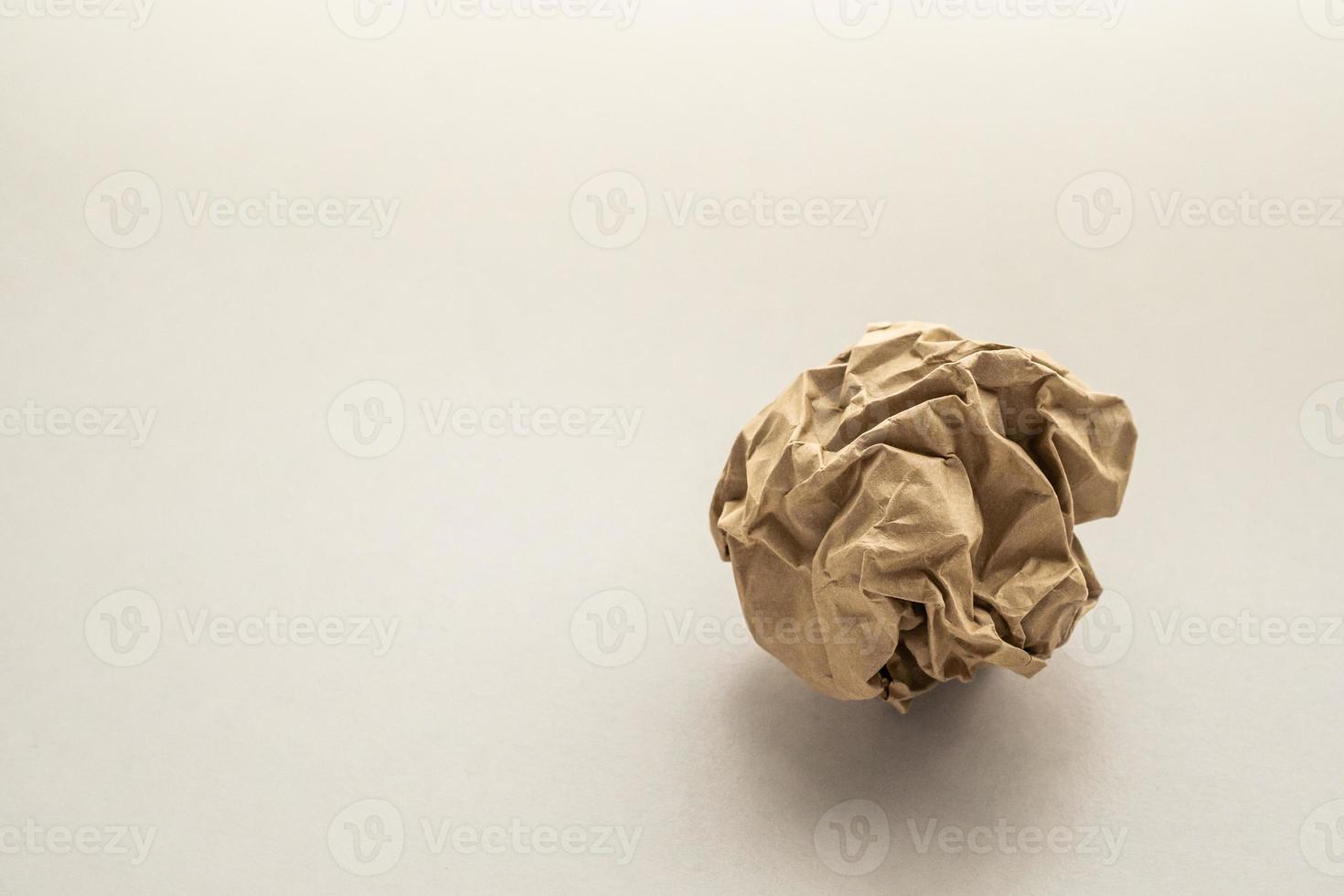 Crumpled recycle brown paper ball photo
