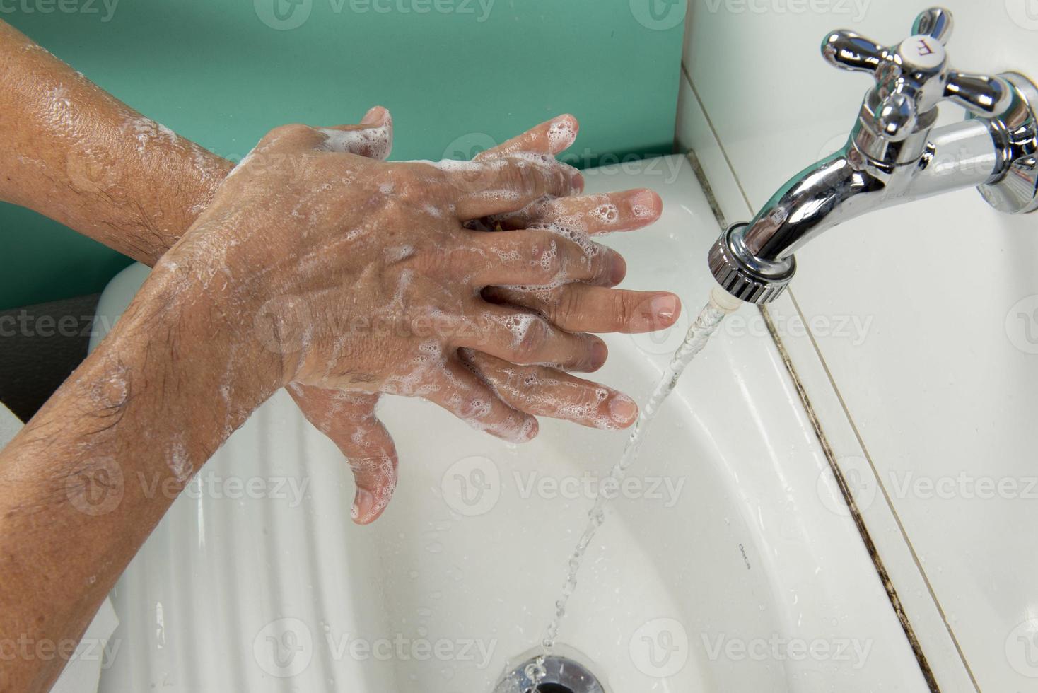 person sanitizing hands photo