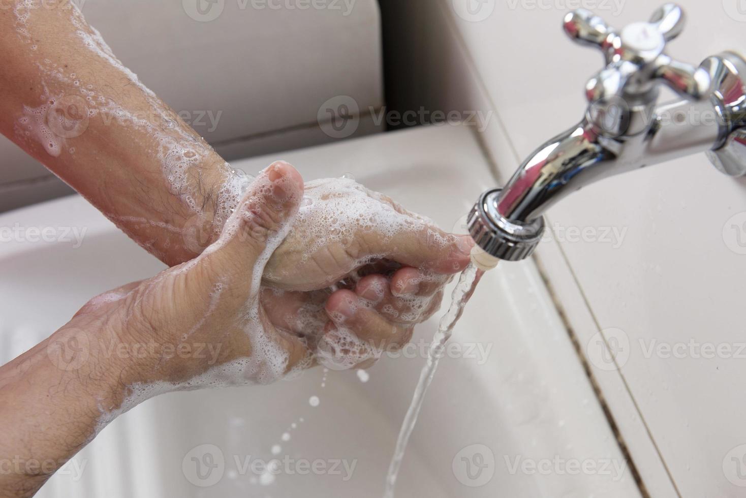 person sanitizing hands photo