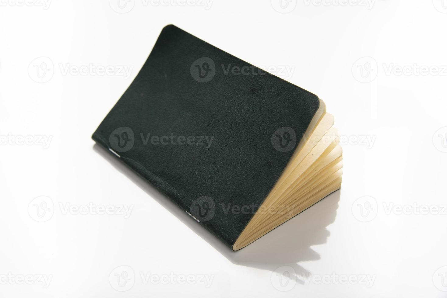 paper note pad with green cover on white background. photo