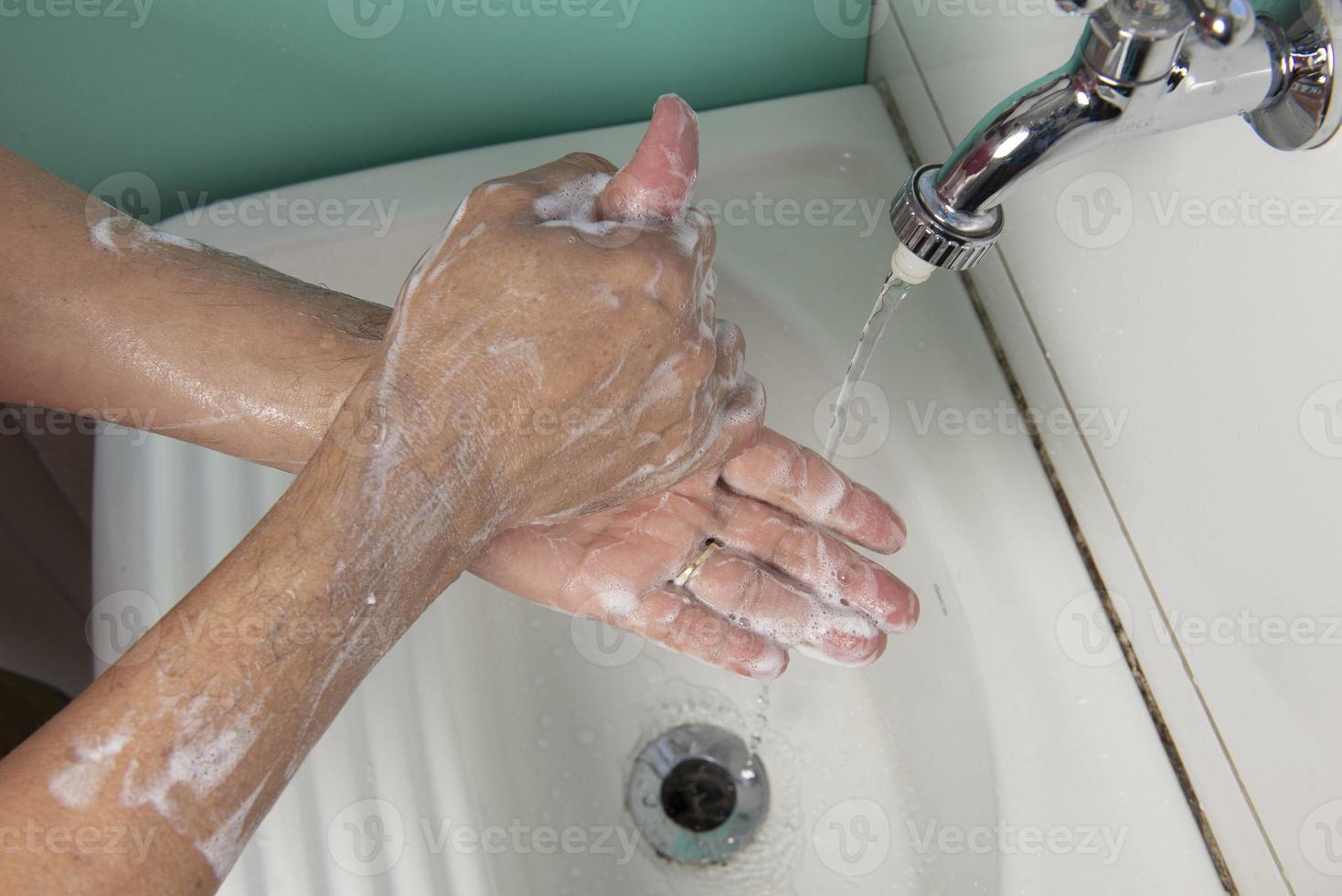 person sanitizing hands photo