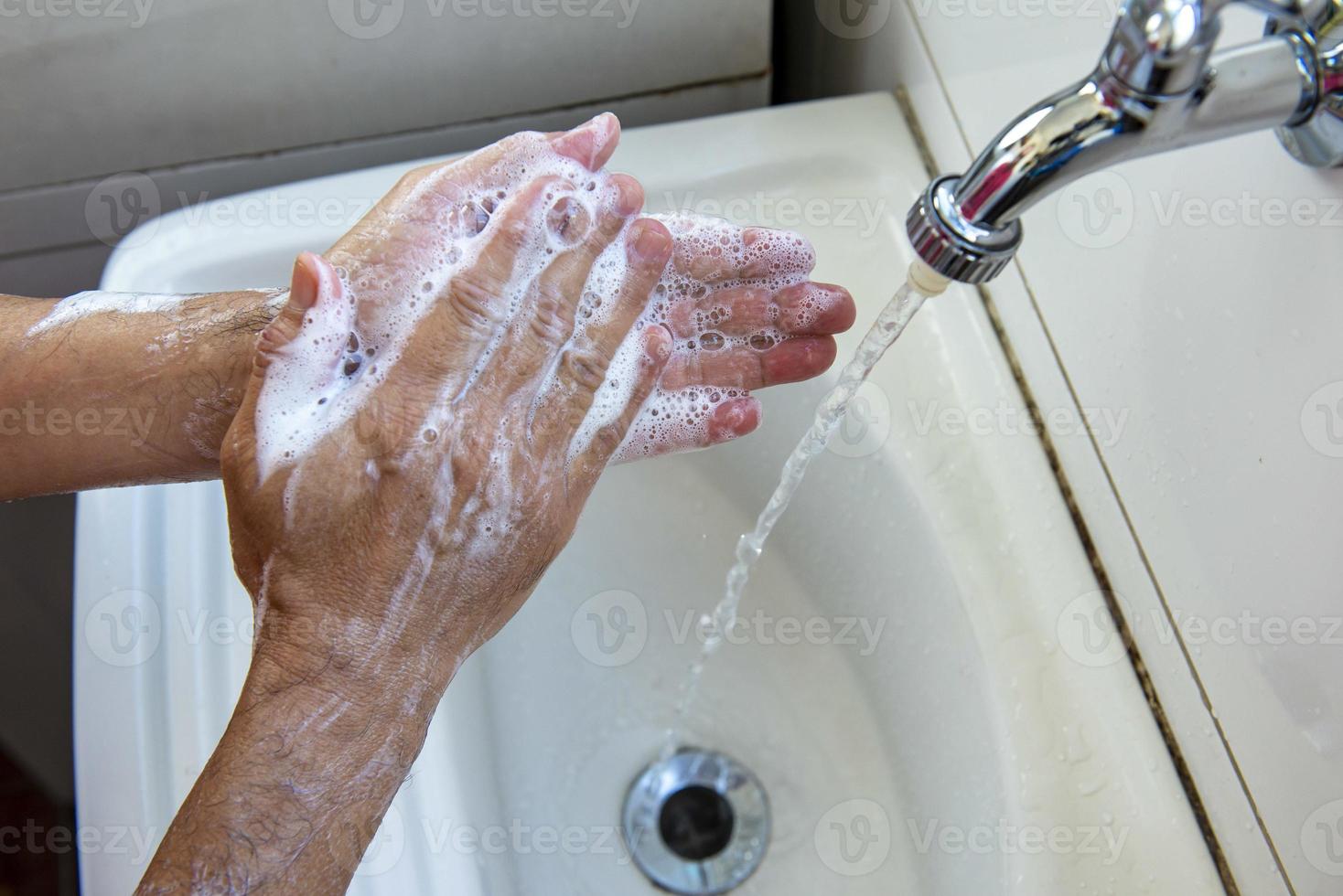 person sanitizing hands photo