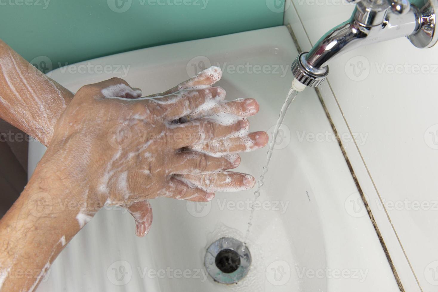 person sanitizing hands photo