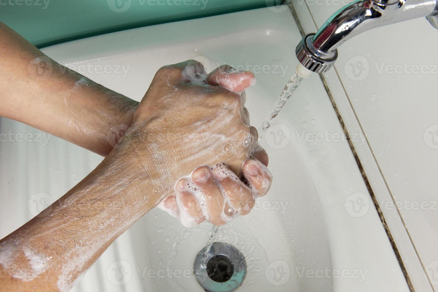 person sanitizing hands photo