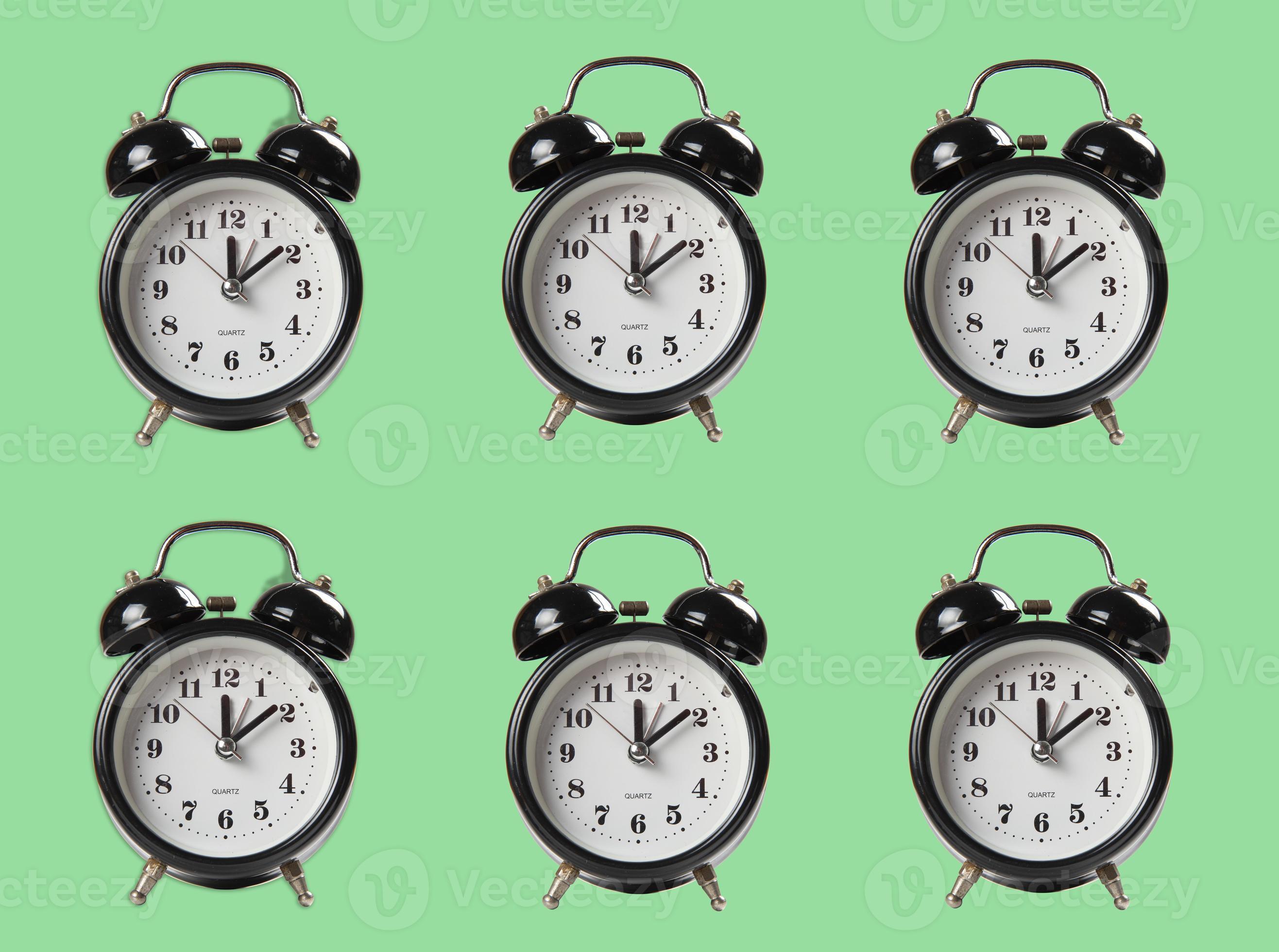 repetition of alarm clock in black color on light green background