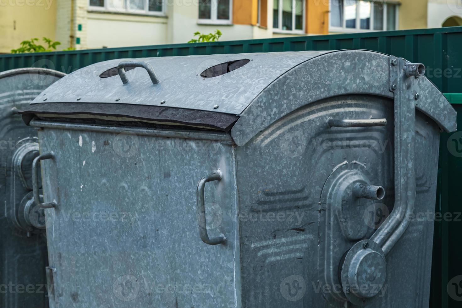 metal trash cans for separate waste collection in a densely populated area of the city photo