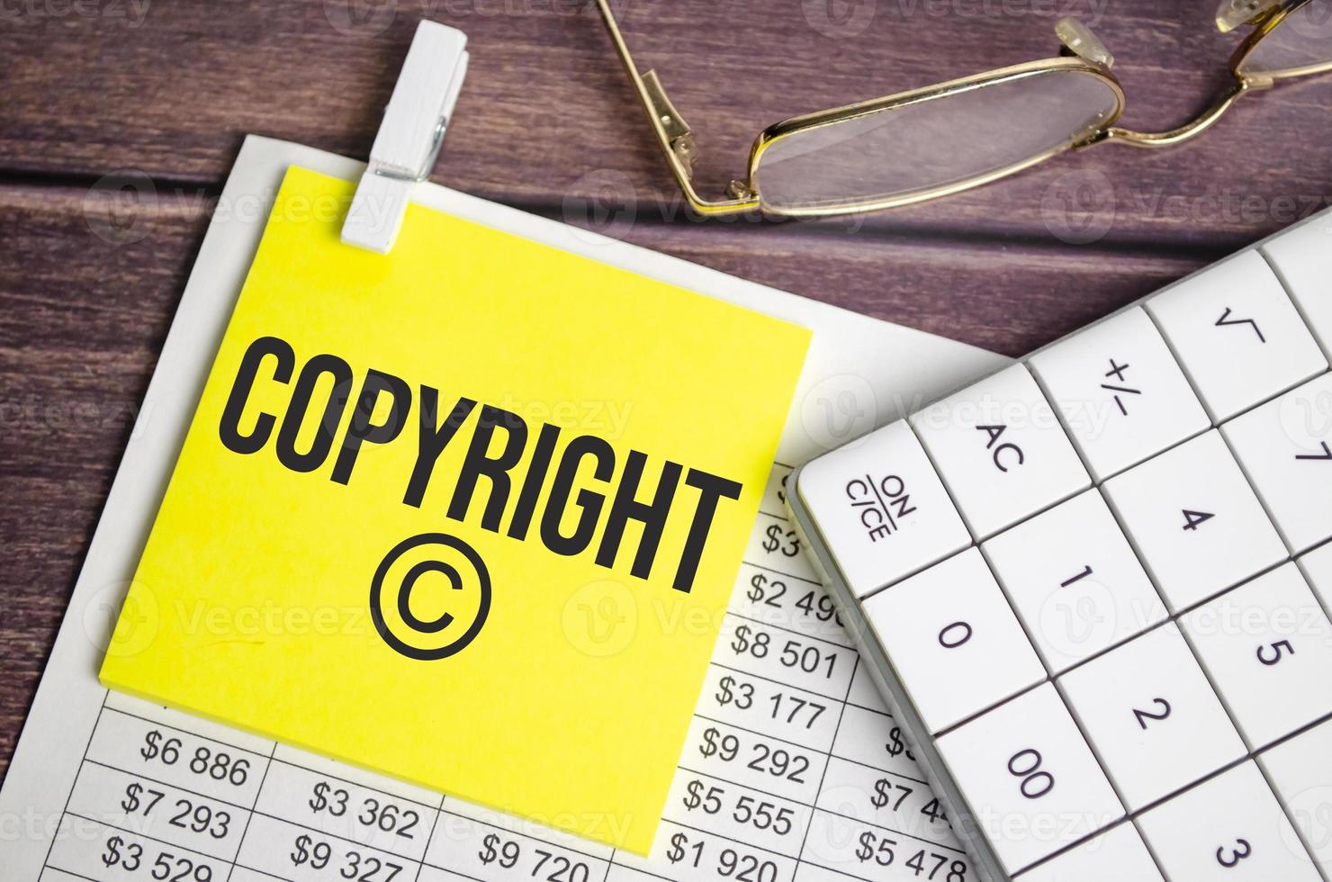 A notepad with the text concept word Copyright a pen, reports, photo