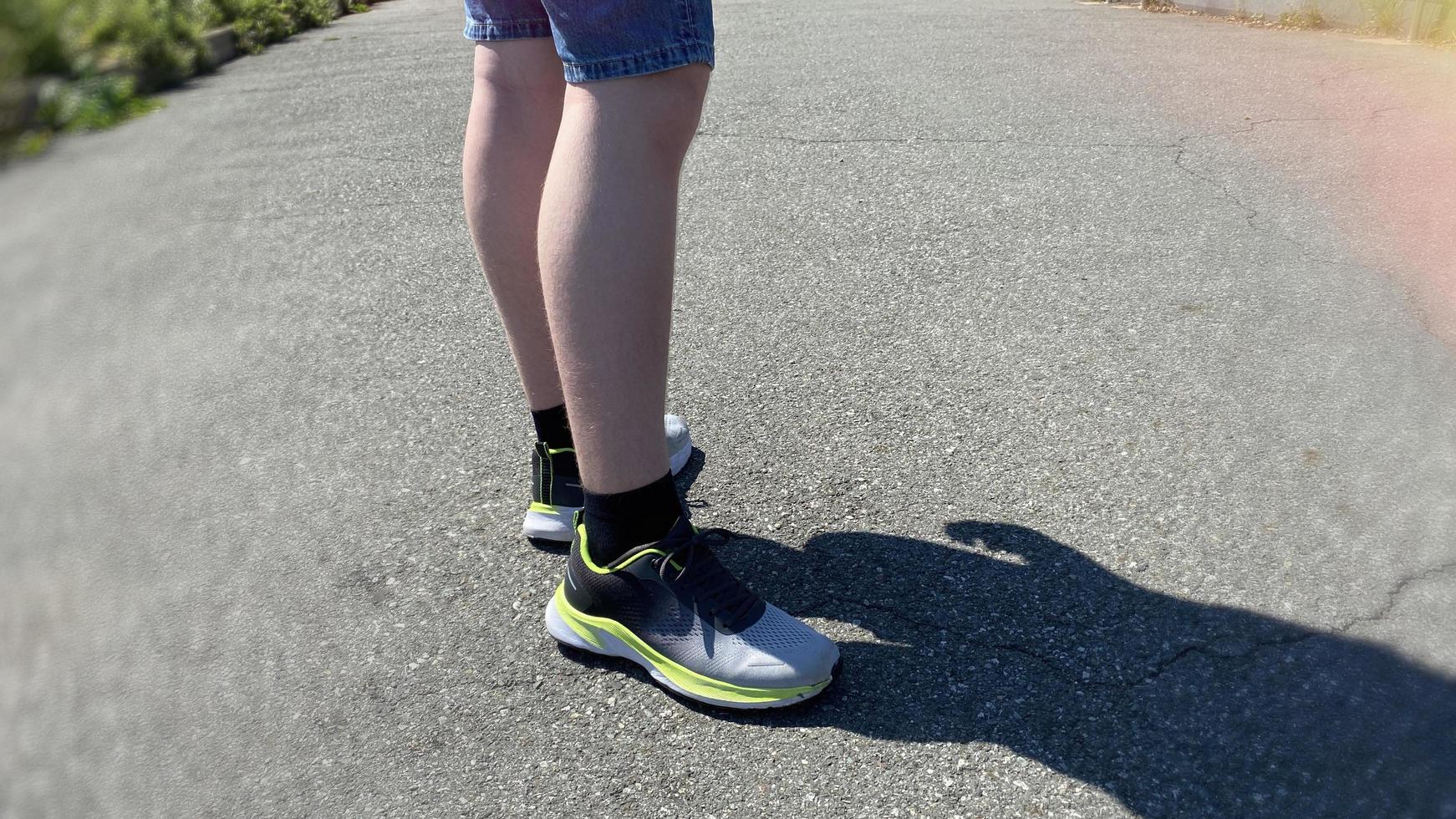 Legs of a young man in sneakers close-up photo