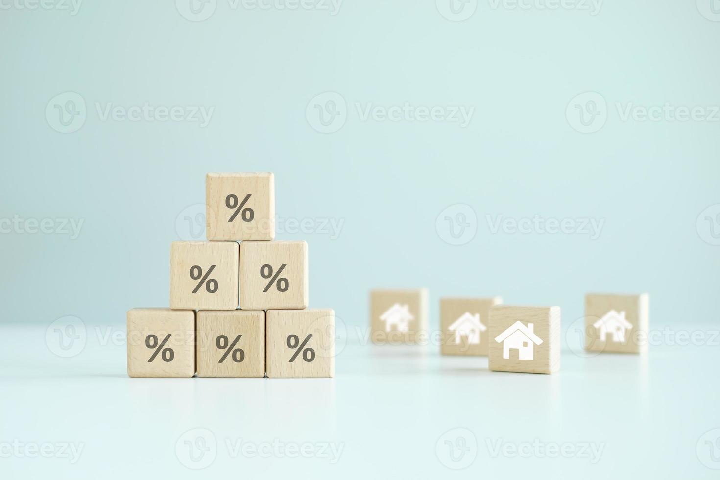 House and property investment, Asset management concept. Inflation, interest rate increase, loan mortgage, house tax, sale discount, home price. Stack of percentage sign and house icon on wood block. photo