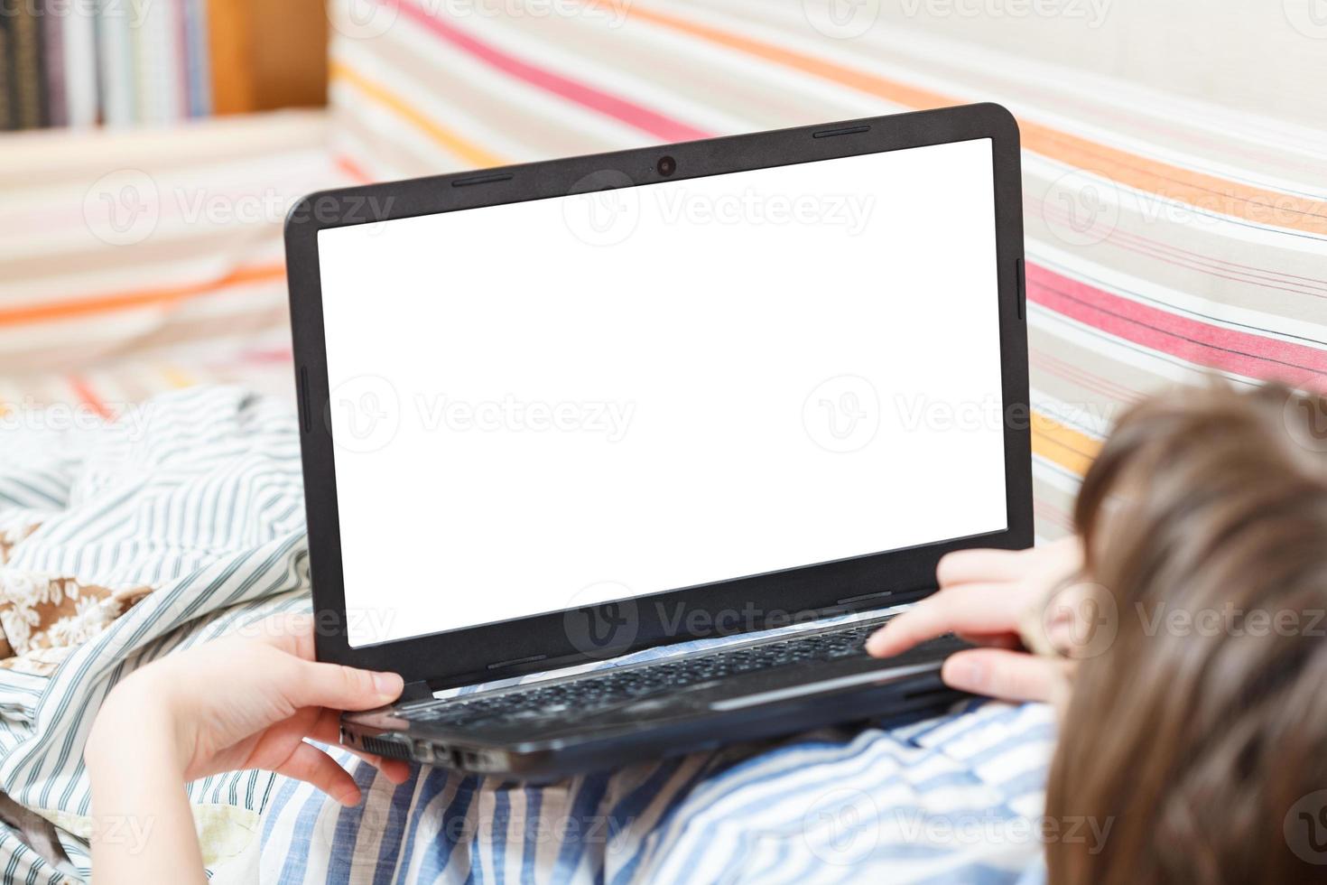 woman works on laptop with cut out screen photo