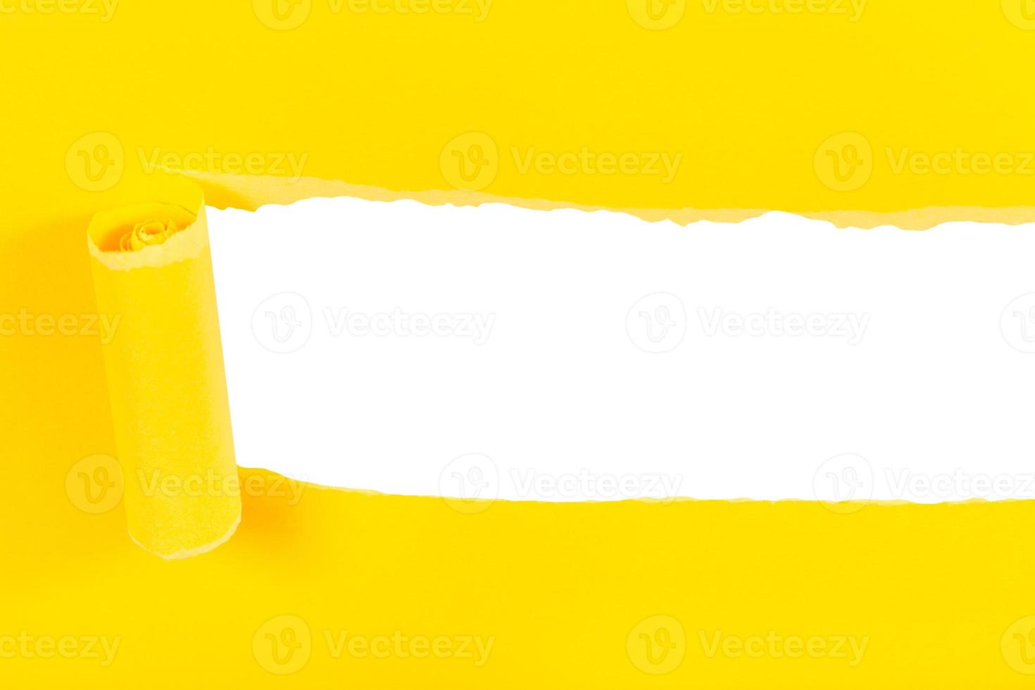 above view of yellow rolled-up torn paper on white photo