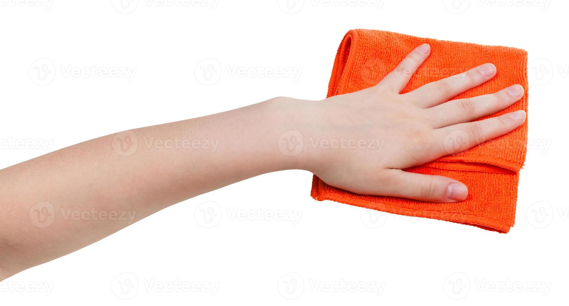 hand with orange dusting rag isolated on whit photo