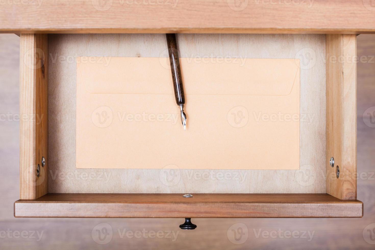 nib pen, paper envelope in open drawer photo